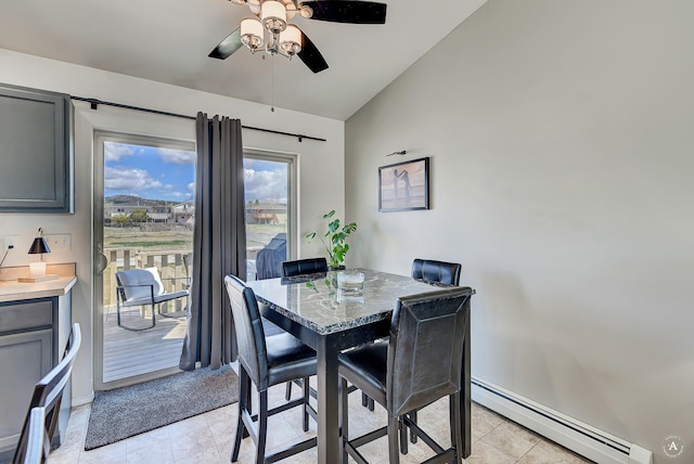 dining area with ceiling fan, vaulted ceiling, light tile patterned floors, baseboards, and a baseboard radiator