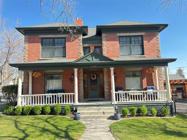 320 Power St, Helena, MT 59601 - view of front of house featuring a porch, brick siding, and a chimney
