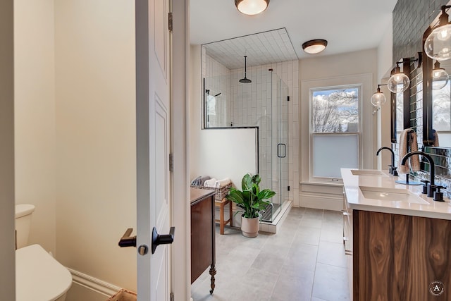 bathroom with vanity, tile patterned flooring, a stall shower, and toilet