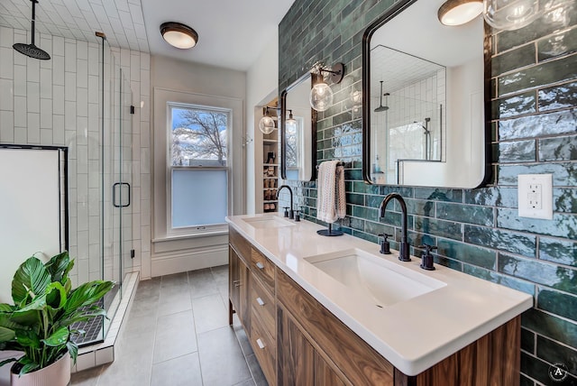 full bathroom featuring double vanity, a sink, tile patterned flooring, and a shower stall