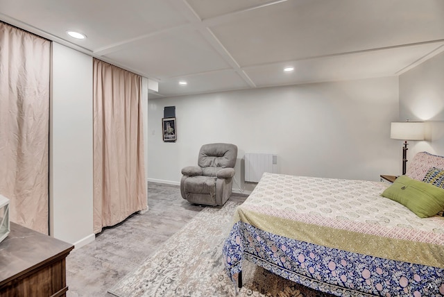 bedroom with radiator, baseboards, recessed lighting, and wood finished floors