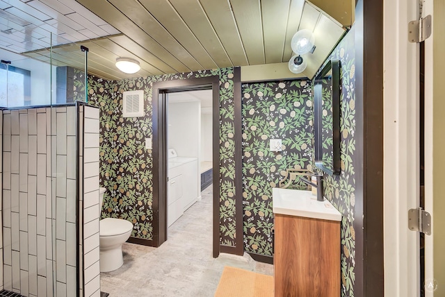 bathroom featuring visible vents, vanity, toilet, wallpapered walls, and washer and clothes dryer
