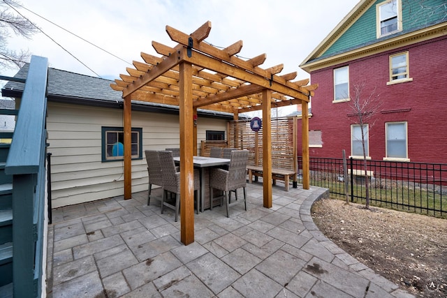 view of patio featuring a pergola, fence, and outdoor dining space