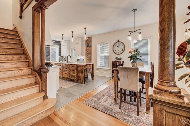 320 Power St, Helena, MT 59601 - dining area featuring ornate columns, stairs, and light wood-type flooring