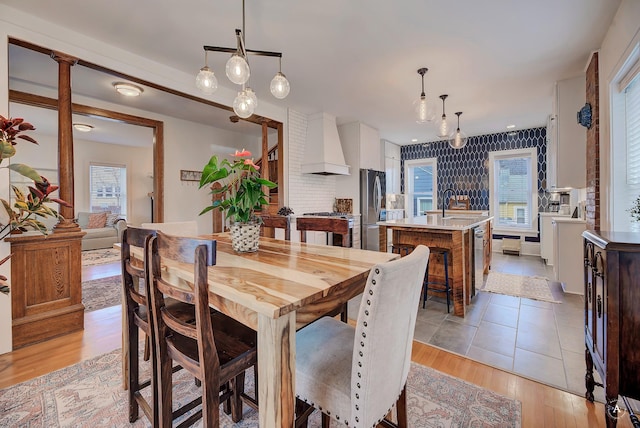 dining space featuring light wood-style flooring