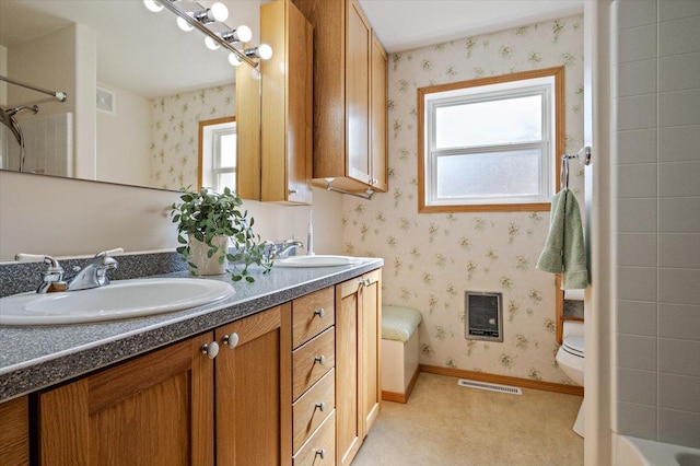 bathroom featuring wallpapered walls, visible vents, a healthy amount of sunlight, and a sink