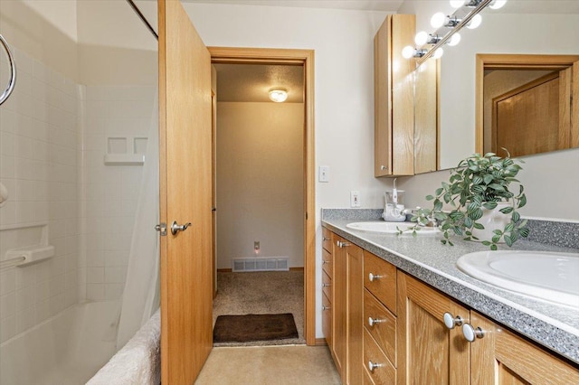 bathroom featuring double vanity, visible vents, a sink, and shower / bath combo with shower curtain