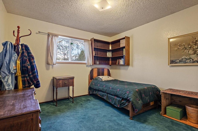 carpeted bedroom featuring a textured ceiling