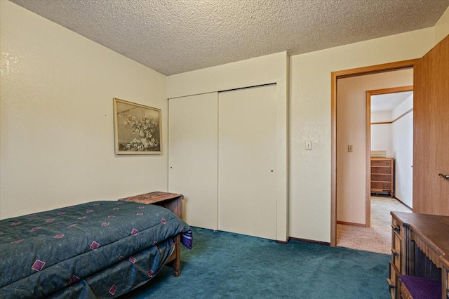 carpeted bedroom with a closet and a textured ceiling