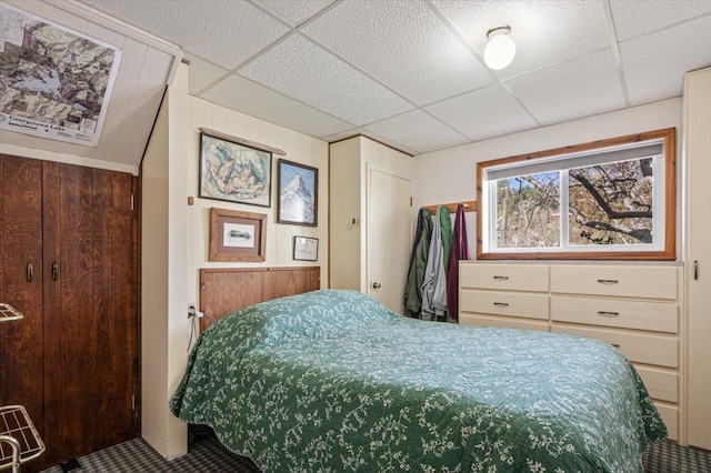 bedroom featuring carpet floors and a paneled ceiling