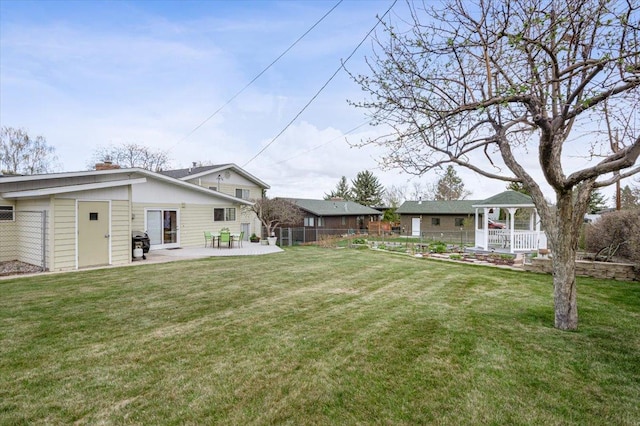 view of yard with fence, a gazebo, and a patio area