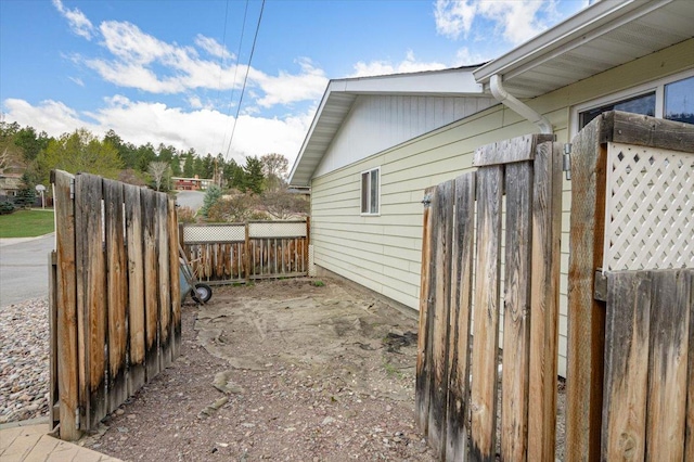 view of side of home featuring fence