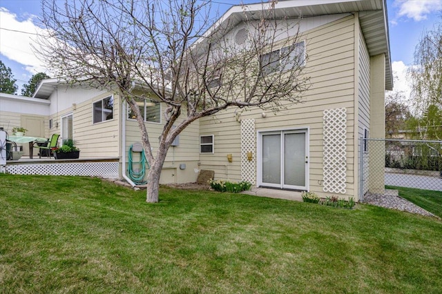 back of property with a lawn