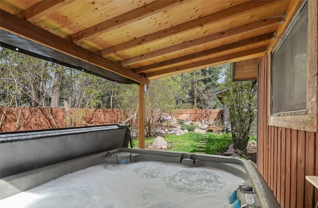 view of patio / terrace featuring a fenced backyard and a hot tub