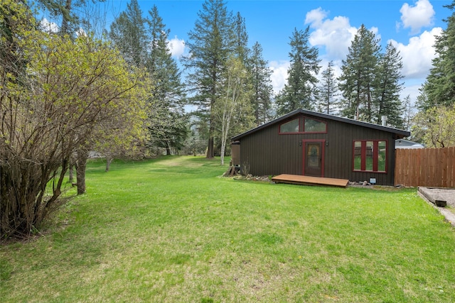 view of yard with fence and a wooden deck