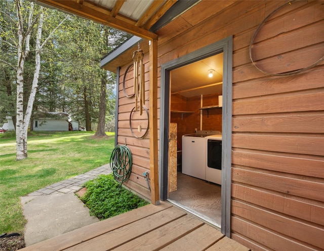 exterior space with a lawn and independent washer and dryer