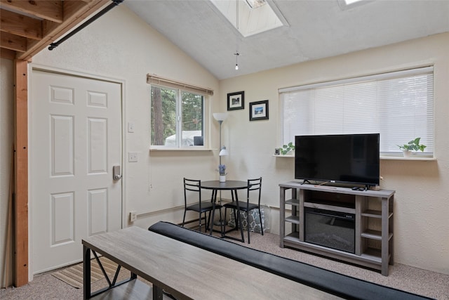living area featuring lofted ceiling with skylight