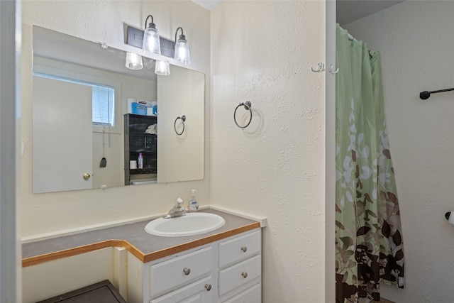 full bathroom with vanity and a shower with curtain