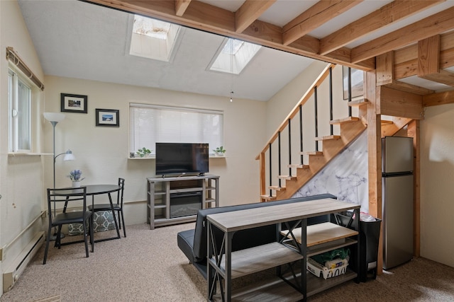 carpeted living room featuring a skylight, a baseboard radiator, stairway, and plenty of natural light