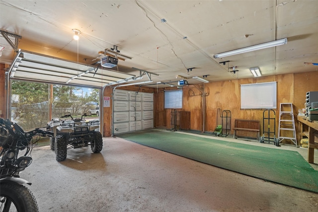 garage featuring wooden walls and a garage door opener