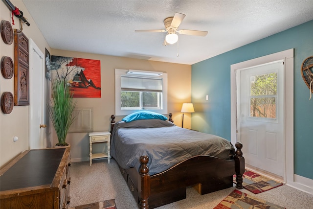 bedroom with carpet floors, a textured ceiling, and ceiling fan