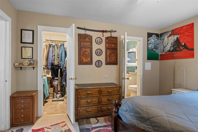 bedroom with a walk in closet, a closet, carpet floors, and connected bathroom