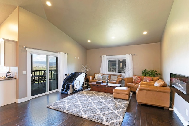 living area with recessed lighting, high vaulted ceiling, and dark wood-type flooring