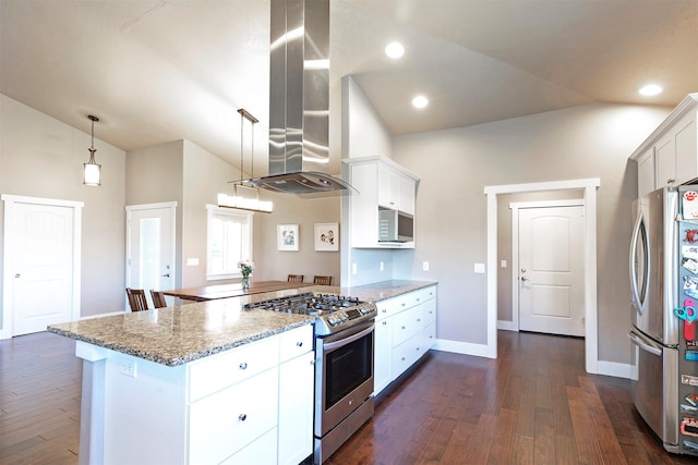 kitchen featuring a peninsula, wall chimney range hood, dark wood finished floors, vaulted ceiling, and stainless steel appliances