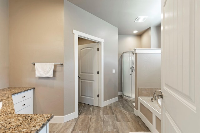 full bathroom featuring a tub, baseboards, a shower stall, and visible vents