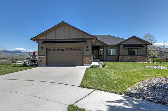 2626 Muirfield Ct, Missoula, MT 59808 - view of front of property featuring an attached garage, concrete driveway, stone siding, and board and batten siding