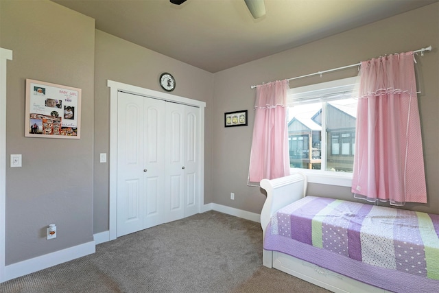 carpeted bedroom with baseboards, a ceiling fan, and a closet