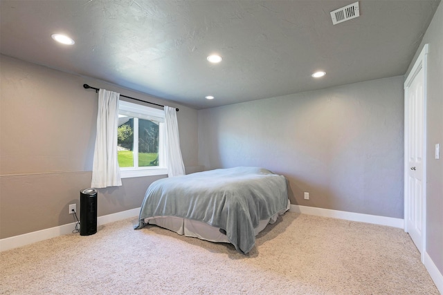 bedroom with carpet floors, recessed lighting, and visible vents