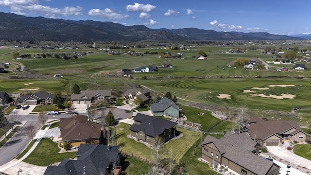 drone / aerial view with view of golf course, a residential view, and a mountain view