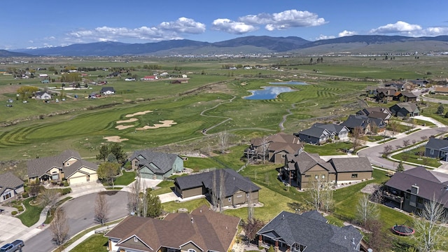 aerial view with a water and mountain view, golf course view, and a residential view