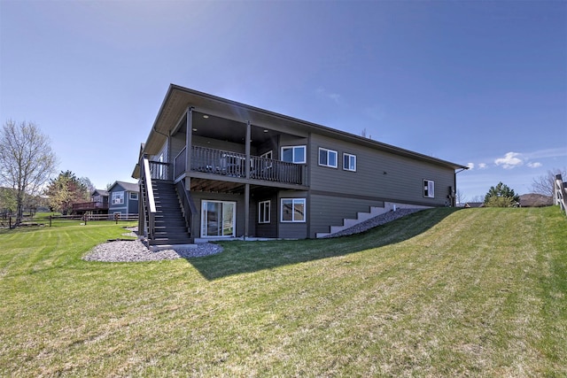 rear view of house featuring fence, a deck, a yard, and stairway
