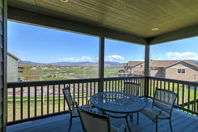 deck with a residential view and a mountain view