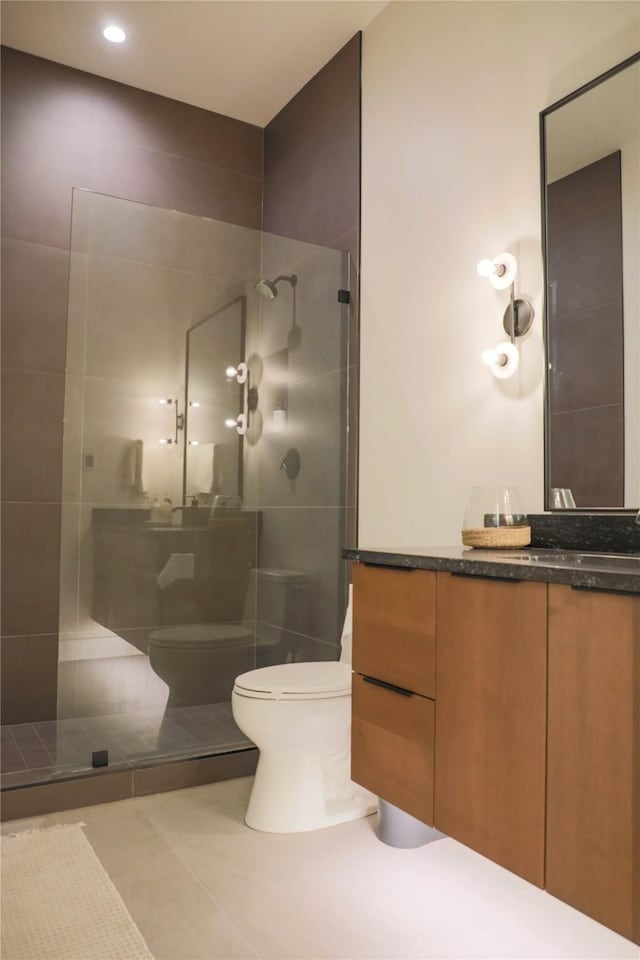bathroom featuring vanity, recessed lighting, walk in shower, and toilet