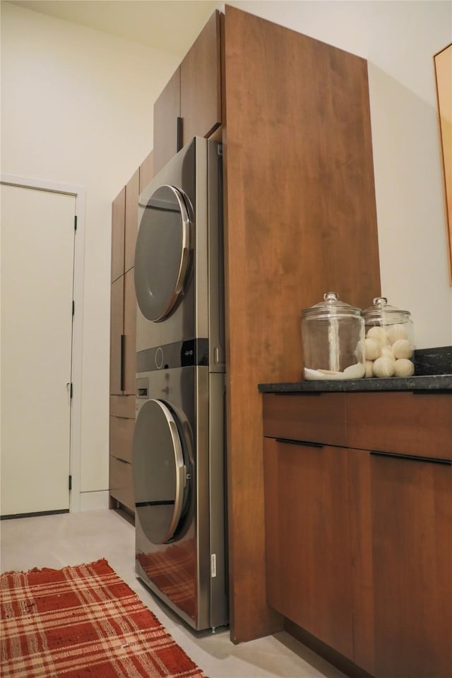 laundry area with stacked washer and dryer and laundry area