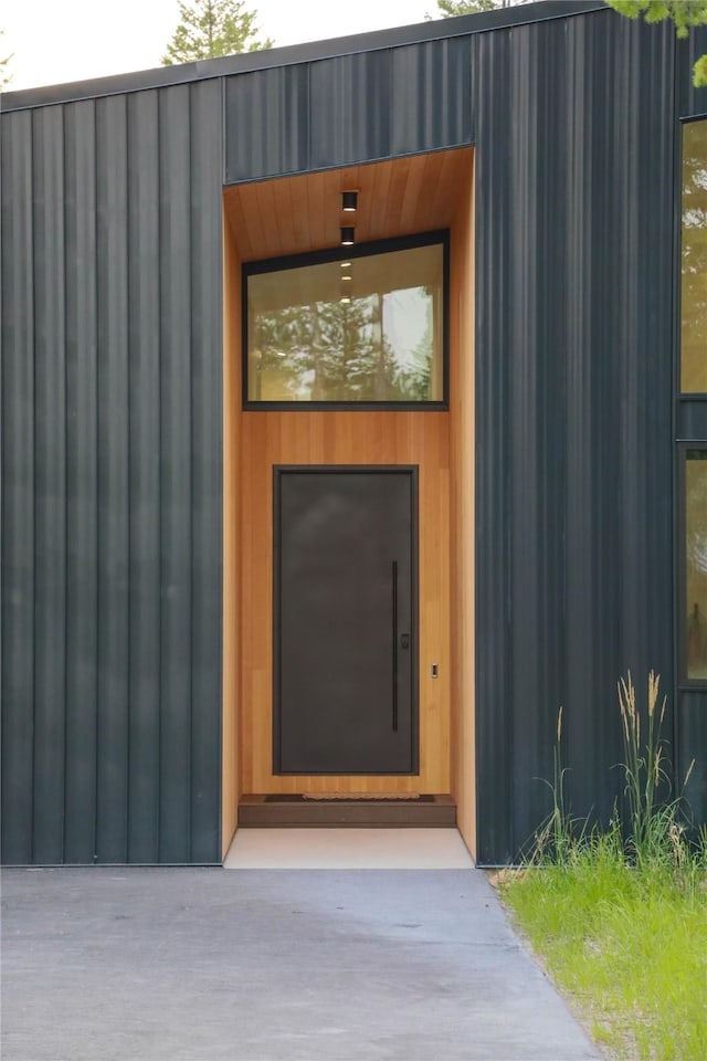 view of exterior entry featuring board and batten siding