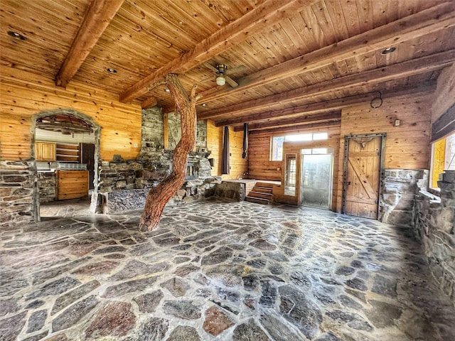 9536 Mt Highway 200, Plains, MT 59859 - living area featuring stone floors, ceiling fan, wooden ceiling, and beam ceiling