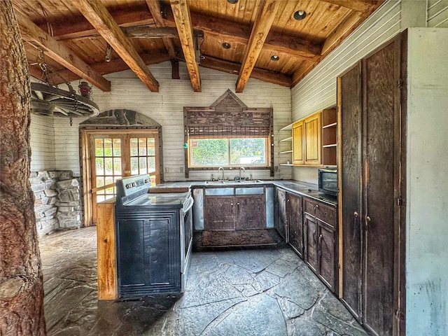 9536 Mt Highway 200, Plains, MT 59859 - kitchen with stone flooring, stainless steel range with electric cooktop, open shelves, and a healthy amount of sunlight