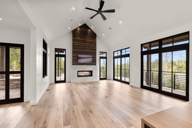 176 S Shooting Star Cir, Whitefish, MT 59937 - unfurnished living room with high vaulted ceiling, a premium fireplace, recessed lighting, light wood-style floors, and ceiling fan