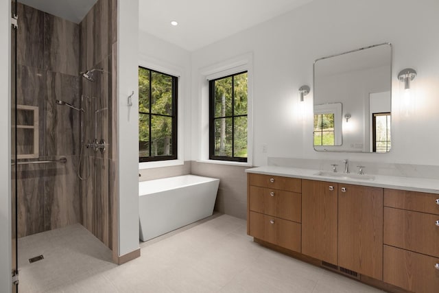 full bath with a freestanding tub, visible vents, a shower stall, and vanity