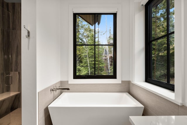 176 S Shooting Star Cir, Whitefish, MT 59937 - full bathroom with tile walls, a freestanding tub, and tiled shower