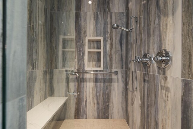 full bath with a marble finish shower