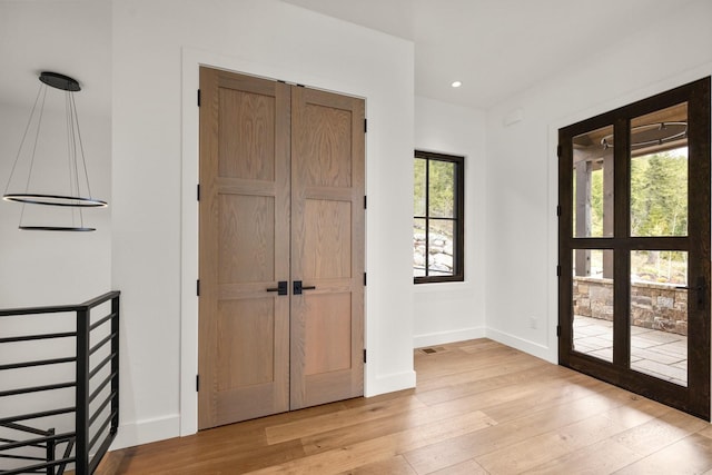 doorway to outside with recessed lighting, baseboards, and light wood-style floors