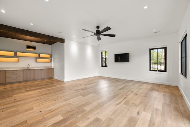 unfurnished living room featuring recessed lighting, a sink, light wood finished floors, and ceiling fan