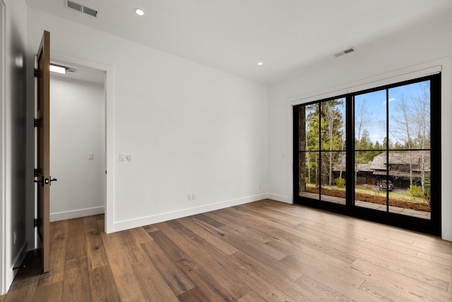 176 S Shooting Star Cir, Whitefish, MT 59937 - empty room with wood finished floors and recessed lighting