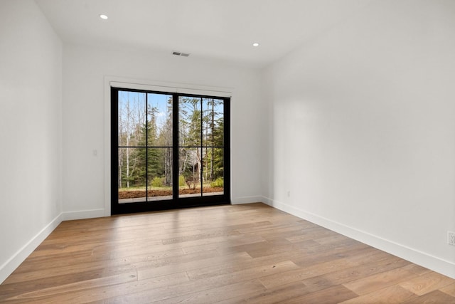 unfurnished room with recessed lighting, visible vents, and light wood-style flooring