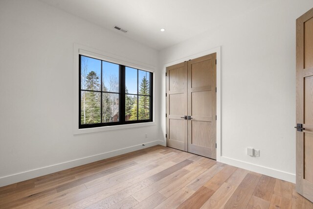 176 S Shooting Star Cir, Whitefish, MT 59937 - unfurnished bedroom featuring light wood-style floors and recessed lighting
